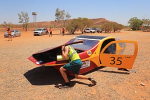A driver of the University of Minnesota solar vehicle project car, Eos II, from the US arrives at the Barrow Creek control stop as it competes in the cruiser class on day three