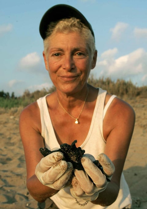 Mona Khalil shows a newborn marine turtle in 2004 near her home in Lebanon