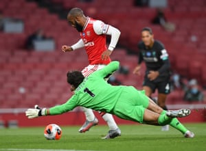 Alexandre Lacazette rounds Alisson before scoring Arsenal’s first goal.