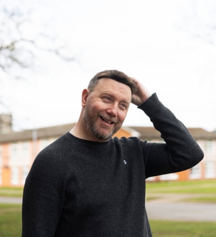 A man looks very pleased with his haircut.