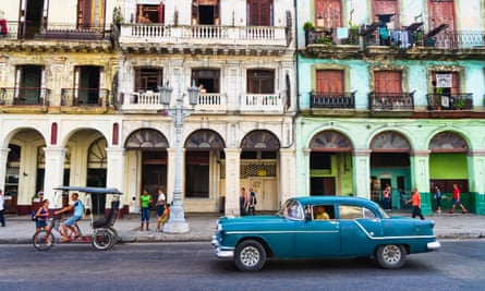 Havana, Cuba. Street scene with old car and worn out buildings.