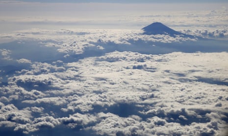 Japan's Mount Fuji, surrounded by clouds, is seen from an airplane.