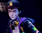 A young male zombie in a baseball cap with a letter R, headphones around his neck.