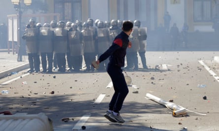 An anti-government protester throws a rock at police in Albanian capital Tirana.