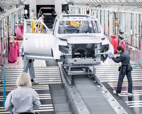 Workers polish a Land Rover on the production line