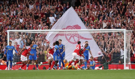 Arsenal's Jurrien Timber celebrates scoring their fourth goal with Martin Zubimendi as the Leeds players look disappointed.