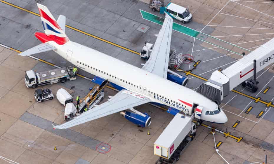 An aerial view of a BA-branded plane being prepared for service by ground crew at Gatwick