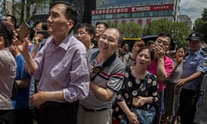 Parents wait for their children to finish taking the gaokao, outside the Beijing Renmin University Affiliated High School, one of the most prestigious in the country.