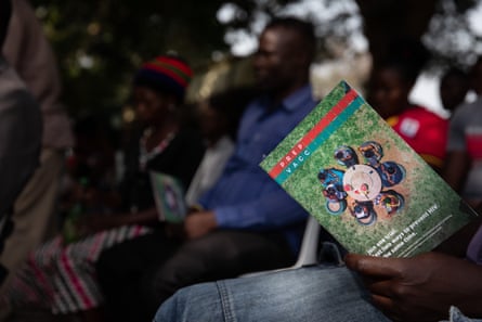 Someone among a group of people reading a pamphlet entitled ‘Prep vacc’