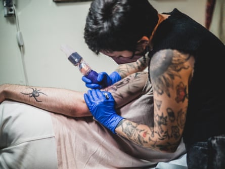 a women with a needle on a person’s arm