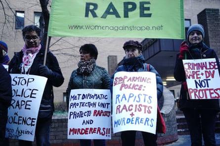 Women hold up signs outside court