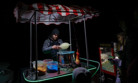 A seller cooks food during a power outage in Kyiv