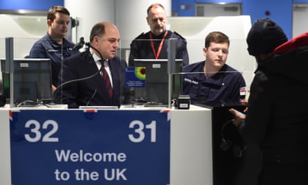 A passport control booth with Ben Wallace and members of the Royal Navy