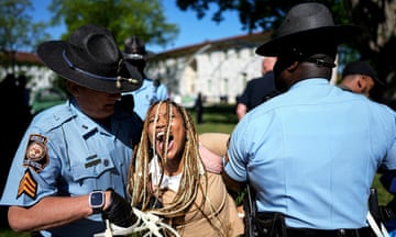 two police officers arresting a young woman