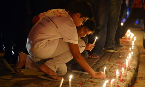 Children light candles during a citizens’ gathering stating ‘We are not afraid’ near the site of a bomb explosion in front of a shopping mall, on 16 January in Jakarta.