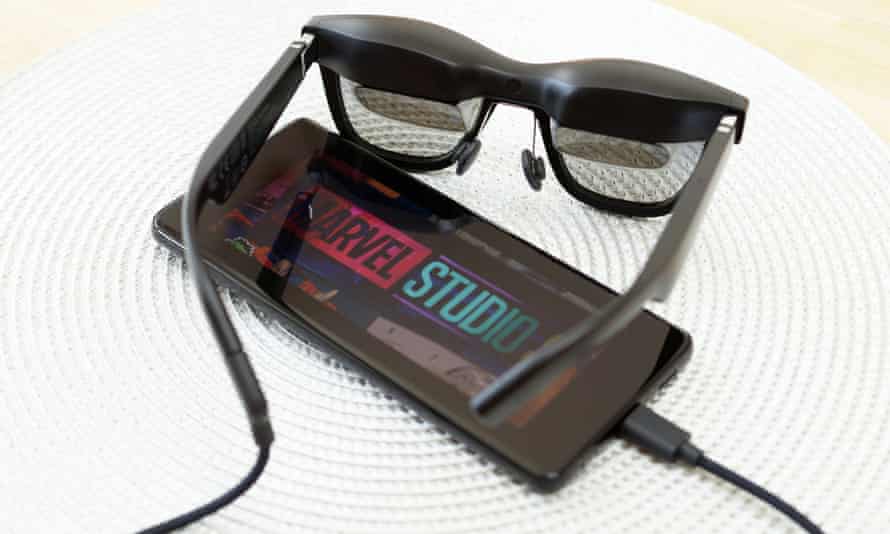 A Marvel Studios logo shown on a smartphone connected to the Nreal Air glasses.