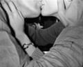 Black and white image of man and woman kissing.