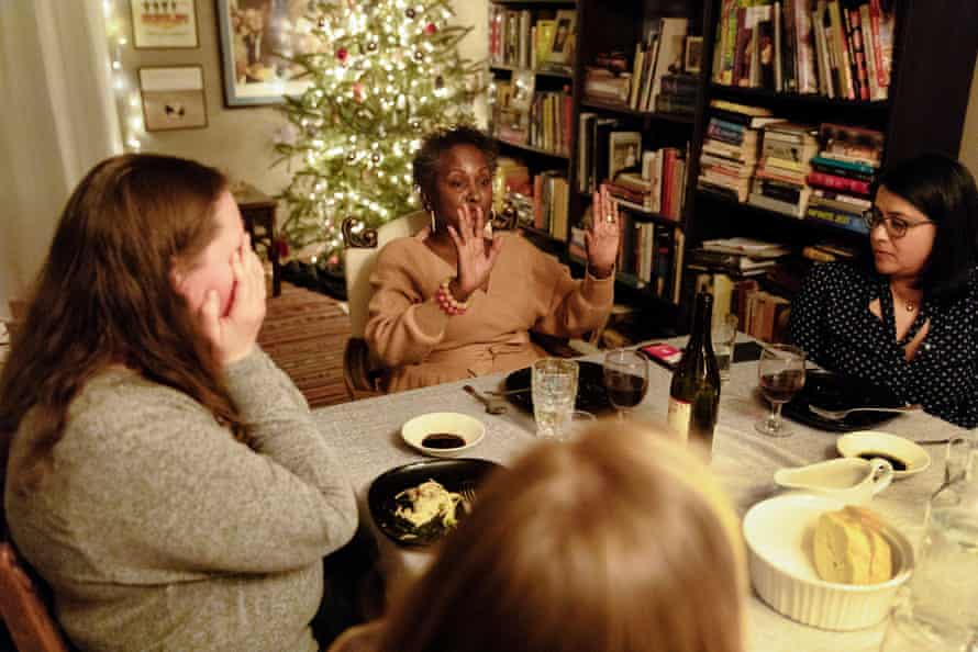 Dinner guests listen to Regina Jackson.