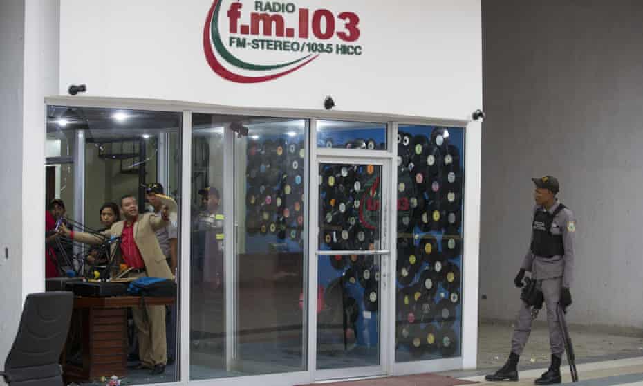 Police investigate the facilities of the f.m. 103.5 radio station following the murder of two members of the media, in San Pedro de Macorís, Dominican Republic, on Tuesday.