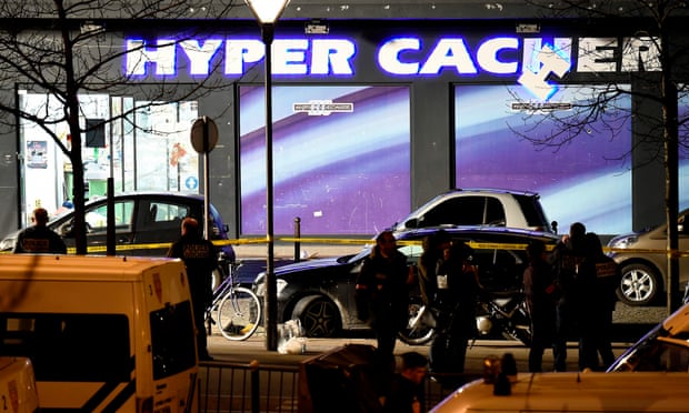 Police officers investigate the scene at the Hyper Cacher kosher supermarket in Paris in 2015.