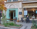 Exterior of Cafe Oto, which has tables outside at which a woman is sitting smoking a cigarette