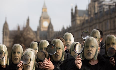 Protesters outside Westminster with Theresa May masks and magnifying glasses