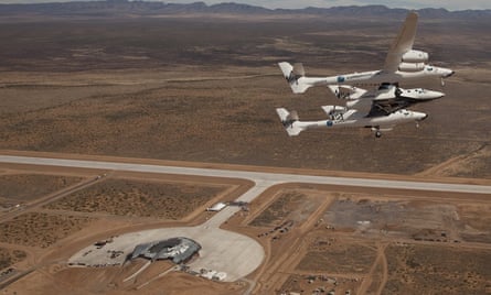 Virgin Galactic vehicles WhiteKnightTwo and SpaceshipTwo fly over Spaceport America in 2010.