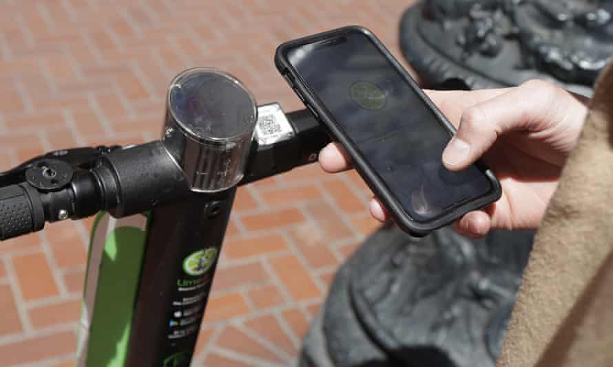 A user logs into an app to use a motorized scooter in San Francisco.