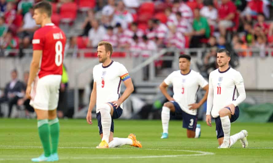 English players are whistled as they kneel before starting