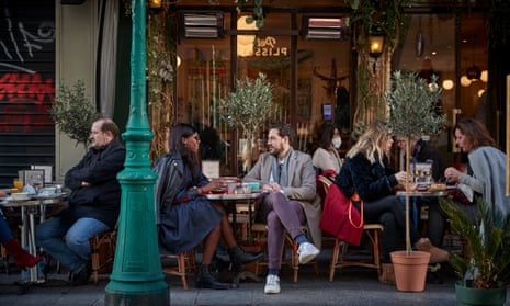 Parisians eat on the terrace of a restaurant in Paris, France as Macron declares his Covid strategy is to ‘piss off’ the unvaccinated by limiting their social activities and making daily life more difficult.