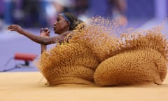 A long jumper lands in the sand