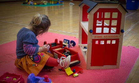 A young girl plays with toys at a playgroup for preschool children
