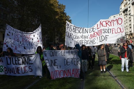 Protesters hold large white banners with messages supporting the movement.