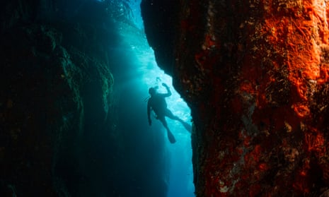 Divers explore an underwater cave