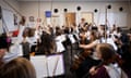 Students raising instrument bows in music class