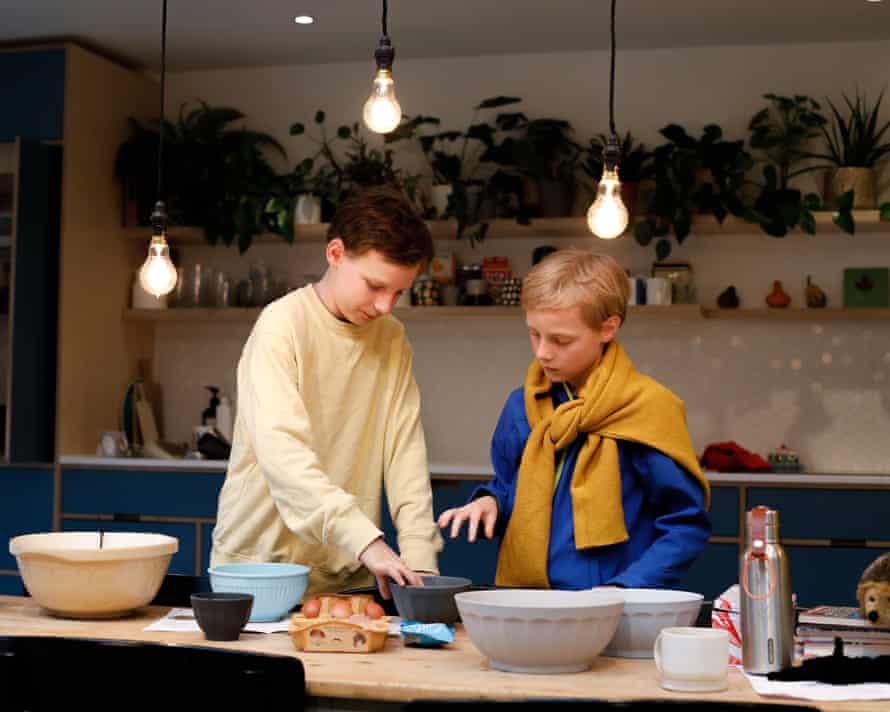Zac, 12 and Isky, 9 making cookies for Ukraine in their kitchen in east London.