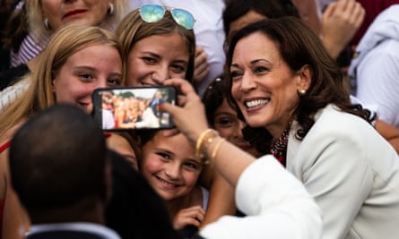 Woman smiles with children to take selfie