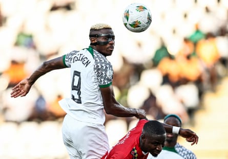 Nigeria’s Victor Osimhen (left) beats Guinea-Bissau’s Opa Sangante to a header.