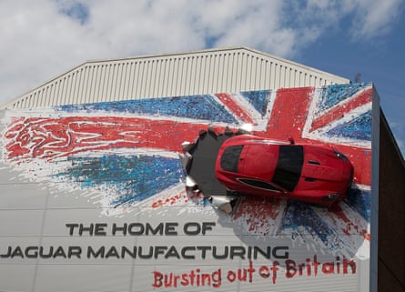A Jaguar car and a union flag cover the wall of Jaguar Land Rover's assembly plant in Castle Bromwich