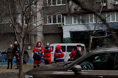 People react at the site of a Russian missile strike in Kyiv.