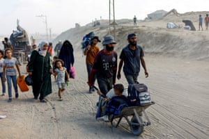 Palestinians flee northern Gaza after Israeli forces ordered residents to evacuate to the south ahead of a military operation