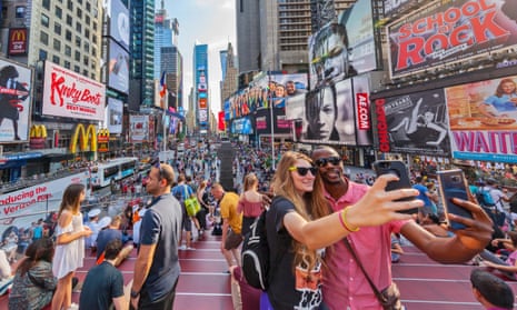 Tourists taking selfies in Times Square, New York.