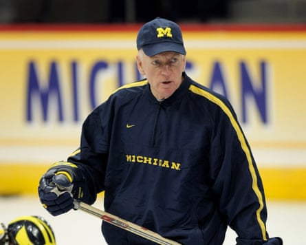 An older man holds a hockey stick An older man holds a hockey stick