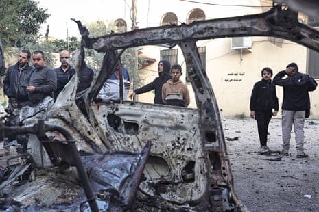 Palestinians inspect the remains of a burnt vehicle in the aftermath of an Israeli raid in the Nur Shams camp for Palestinian refugees near the northern city of Tulkarm in the occupied West Bank.