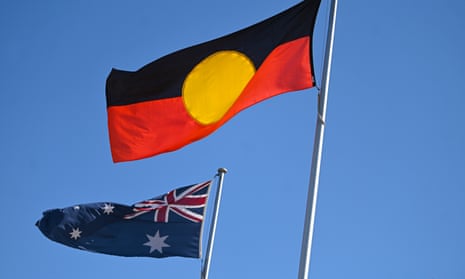 An Australian flag and an Aboriginal flag fly in Canberra