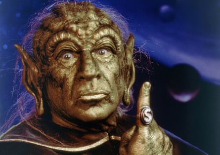 film still of man in gold makeup