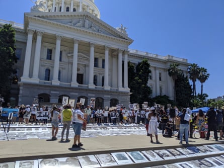 Activists lay images of people of color killed by police at the state capitol.