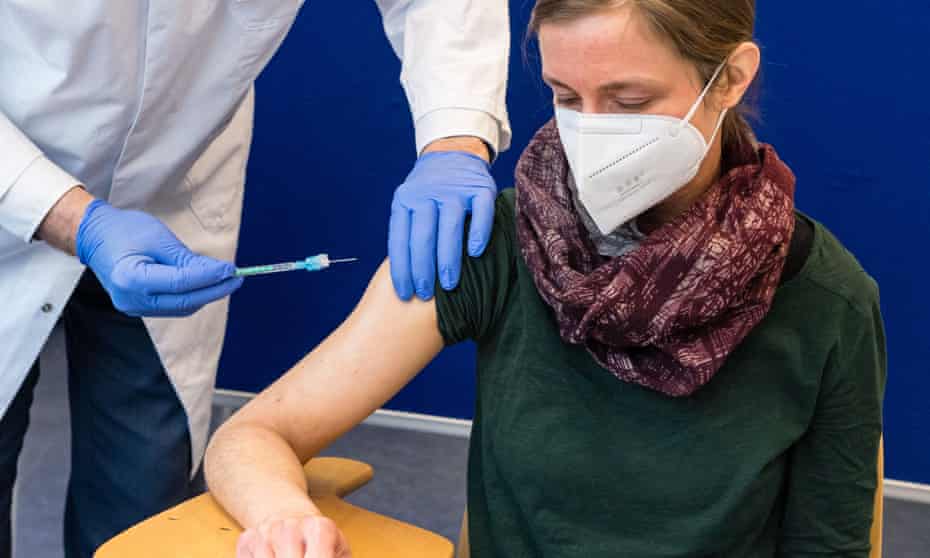 A healthcare worker receives the AstraZeneca vaccine at the university hospital in Halle, Germany.