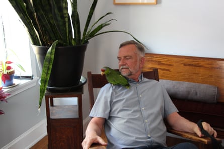 a man with a parrot on his shoulder
