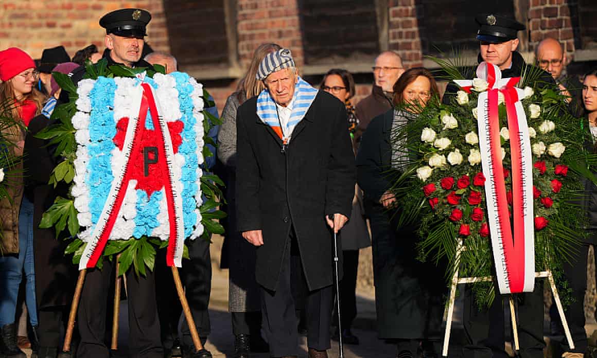 A survivor attends a wreath-laying ceremony at the Death Wall during the 80th anniversary of the liberation of the Nazi Auschwitz-Birkenau concentration and extermination camp in Oswiecim, Poland